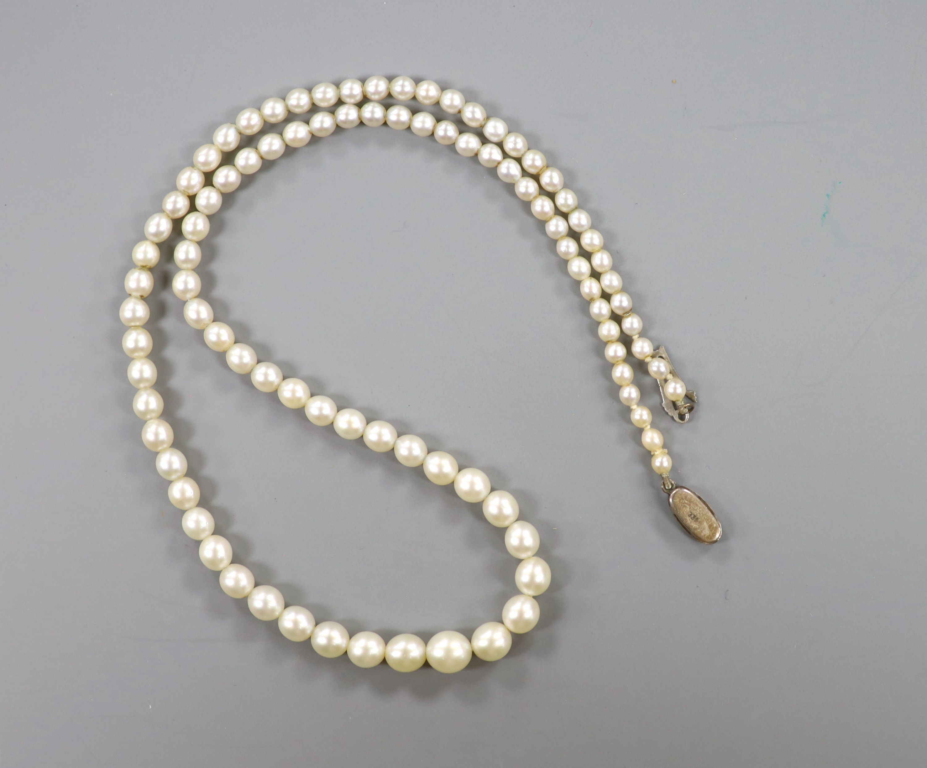 A single strand and graduated cultured pearl necklace, with marcasite set clasp, 44cm and a pair of 9ct and simulated pearl drop earrings.